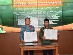 Bupati Lamongan Yuhronur Efendi (kiri) menandatangani MoU Ketahanan Keluarga.