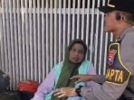 Pamapta Polres Lamongan membantu ibu pingsan.