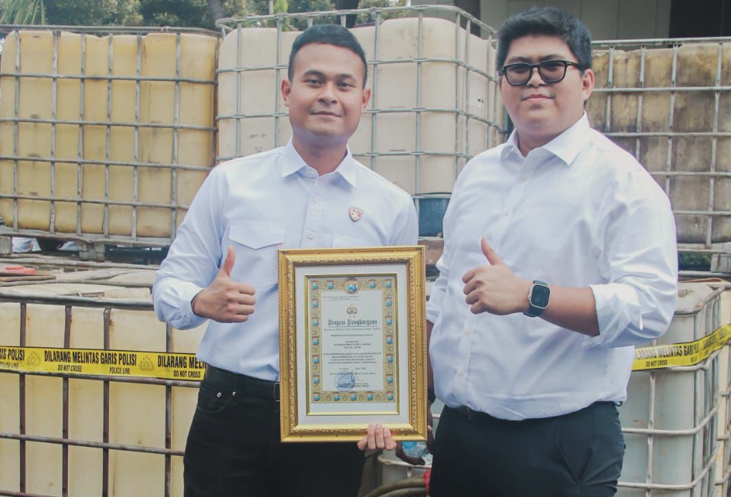 Kasat Reskrim Polres Gresik AKP Arya Widjaya (kanan) bersama Kanit Tipidter Iptu Komang Andhika Haditya Prabu menunjukkan piagam penghargaan Kapolda Jatim dan barang bukti 17 solar subsidi.