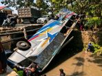 IMG-20260704-WA0016 Bus Sugeng Rahayu yang terbalik ke dalam sungai di Dusun Kandangrejo, Desa Paron, Kecamatan Bagor, Nganjuk, setelah terlibat kecelakaan