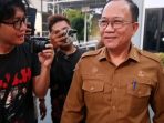 Sekda Nganjuk, Nur Solekan, saat berjalan keluar dari Kantor Kejari Nganjuk usai menjalani pemeriksaan selama 8 jam terkait dugaan kasus korupsi Bendungan Margopatut